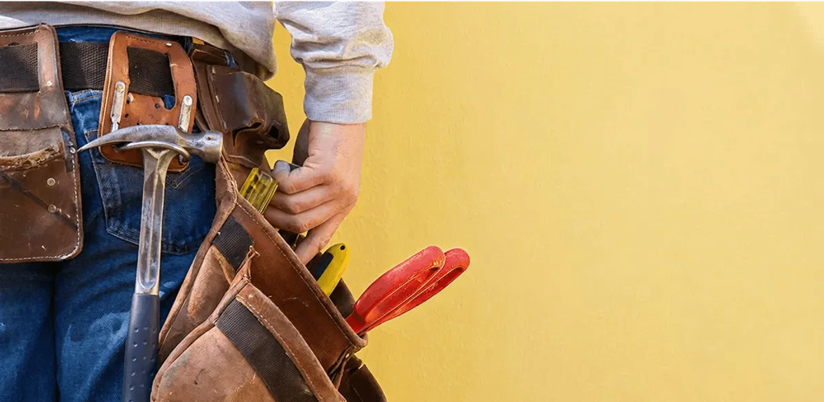 Handyman with tool belt ready for home repairs and maintenance in Pembroke Pines, FL