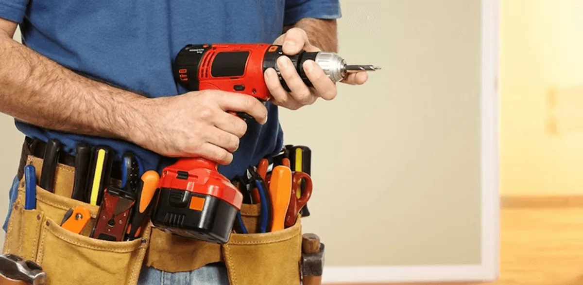 Handyman holding a power drill for home repairs and installations in Pembroke Pines, FL